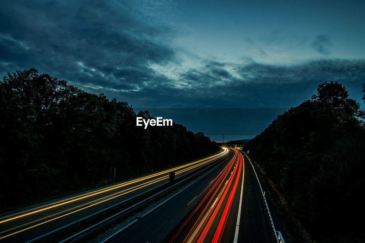 high angle view of light trails on road against sky at night