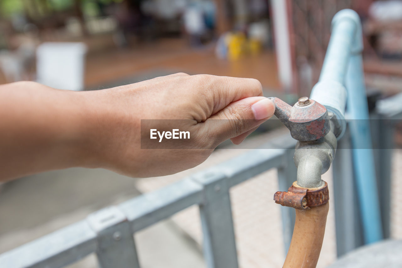 Cropped hand of person holding metal