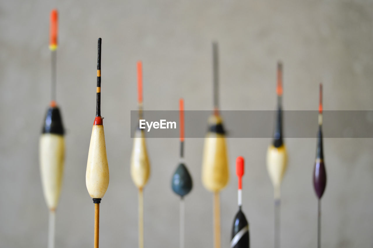 CLOSE-UP OF MULTI COLORED PENCILS HANGING FROM ROOF