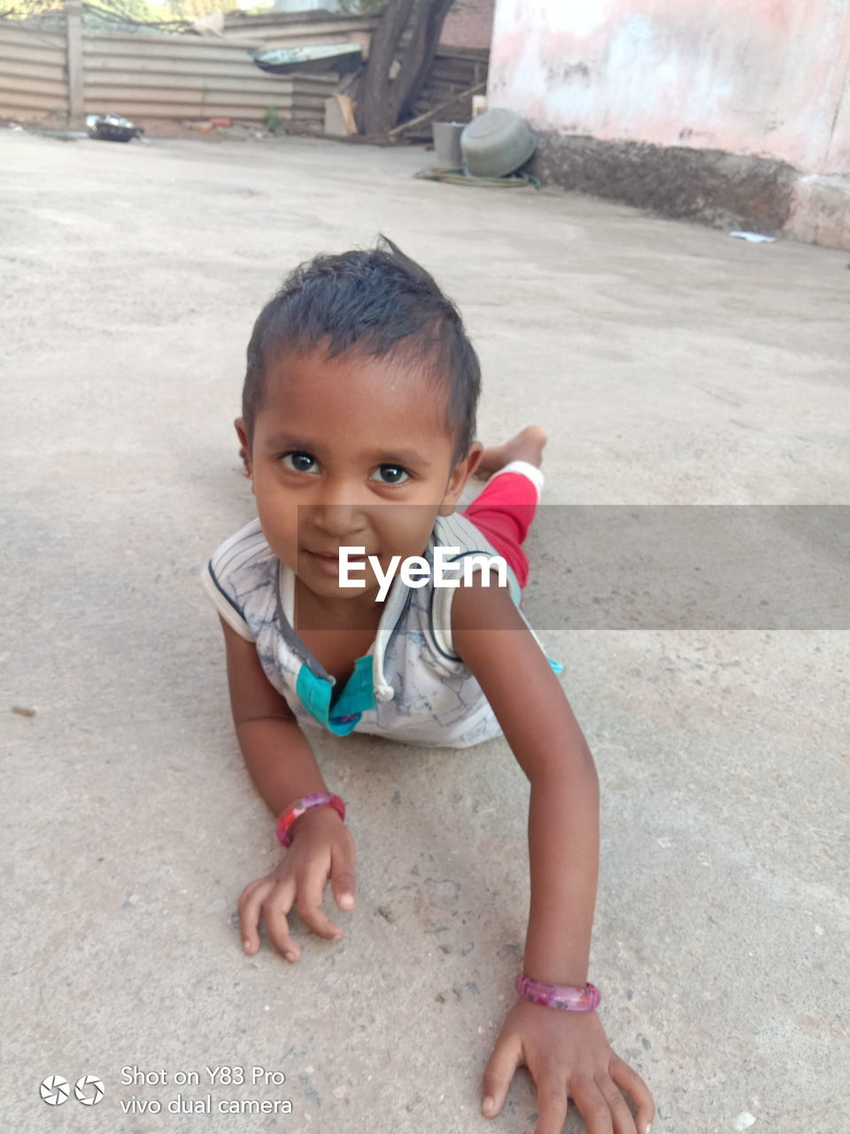 HIGH ANGLE PORTRAIT OF CUTE SMILING GIRL ON STREET