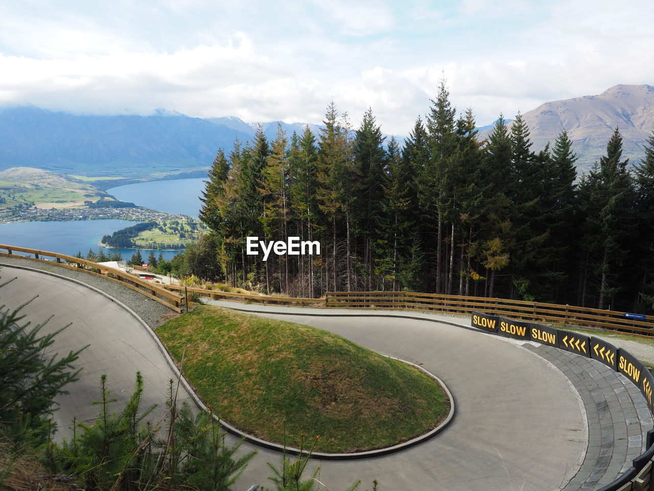 High angle view of road amidst trees against sky