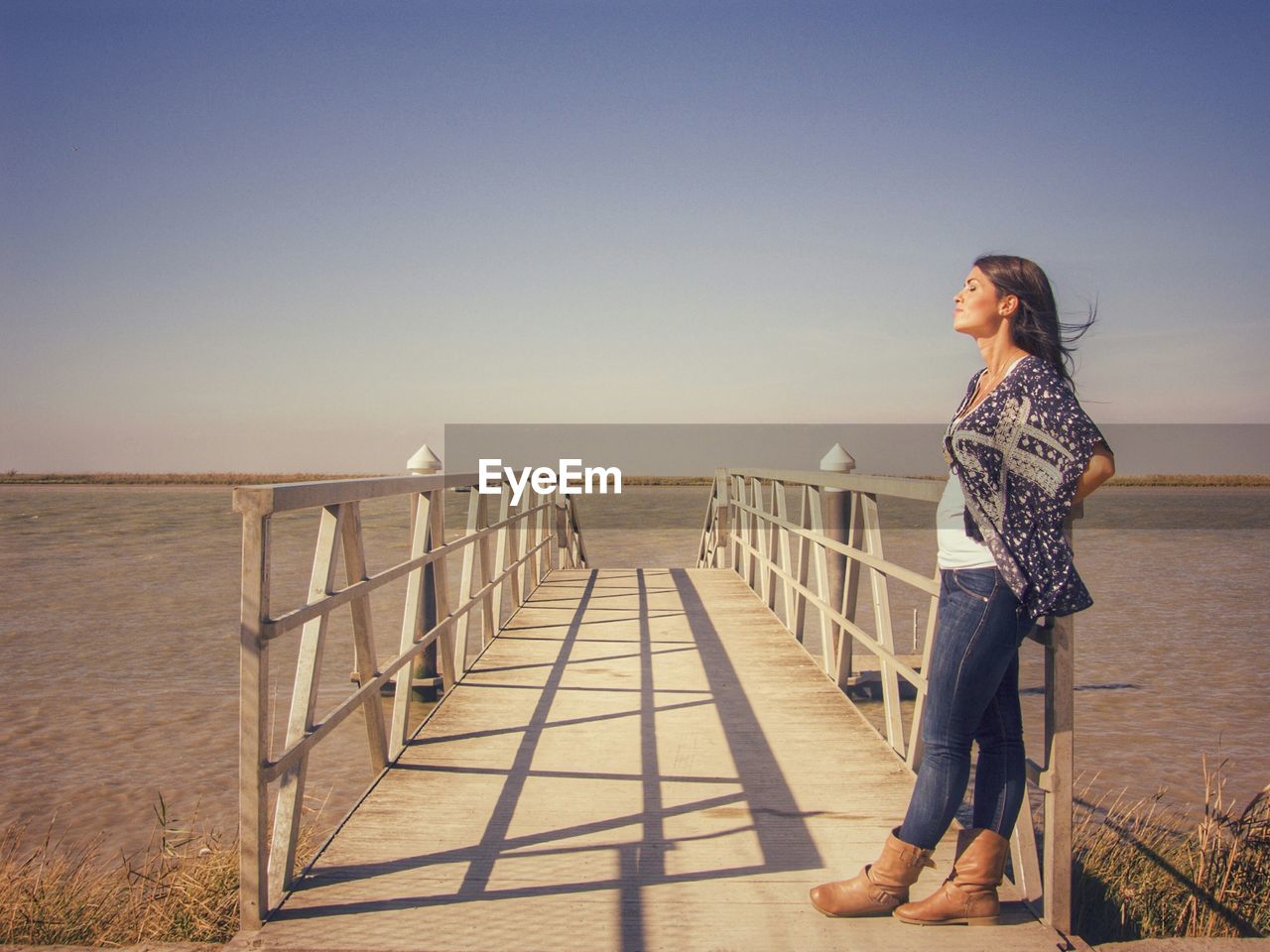 Woman on beach against clear sky