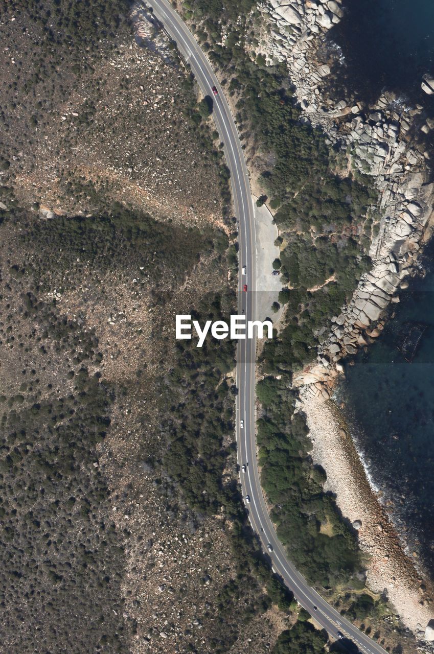 Aerial view of winding road on mountain by sea