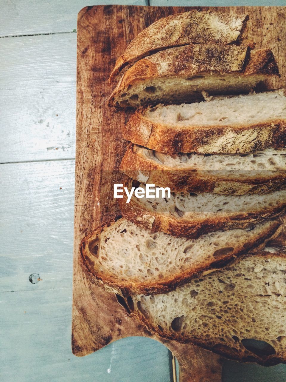 CLOSE-UP OF BREAD ON WOOD IN CONTAINER