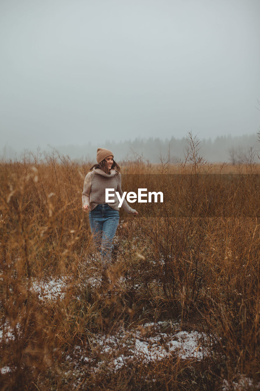 WOMAN STANDING ON FIELD