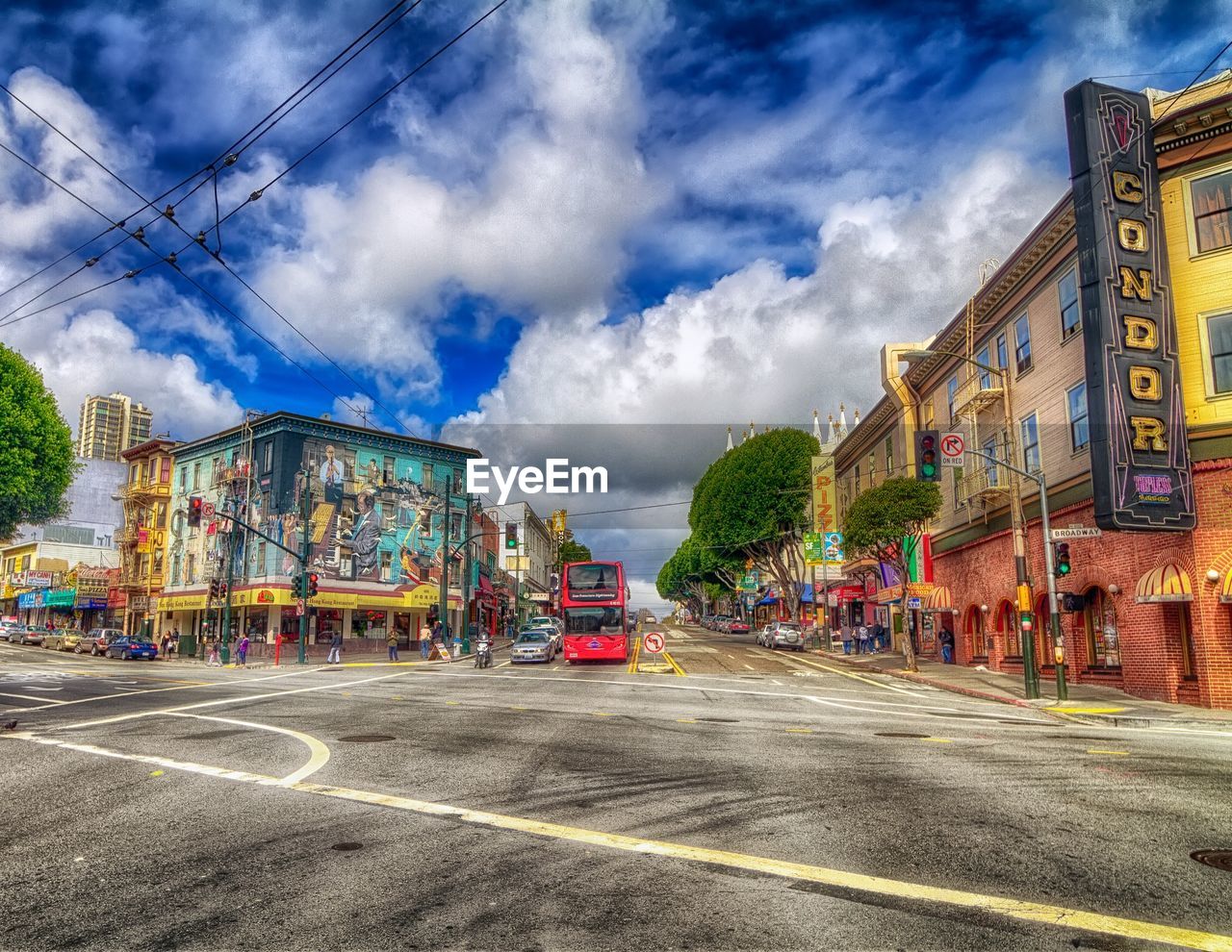 VIEW OF CITY STREET AGAINST CLOUDY SKY