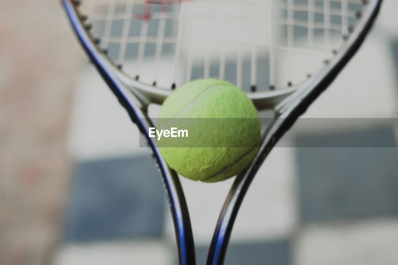 Close-up of tennis ball on tennis racket 