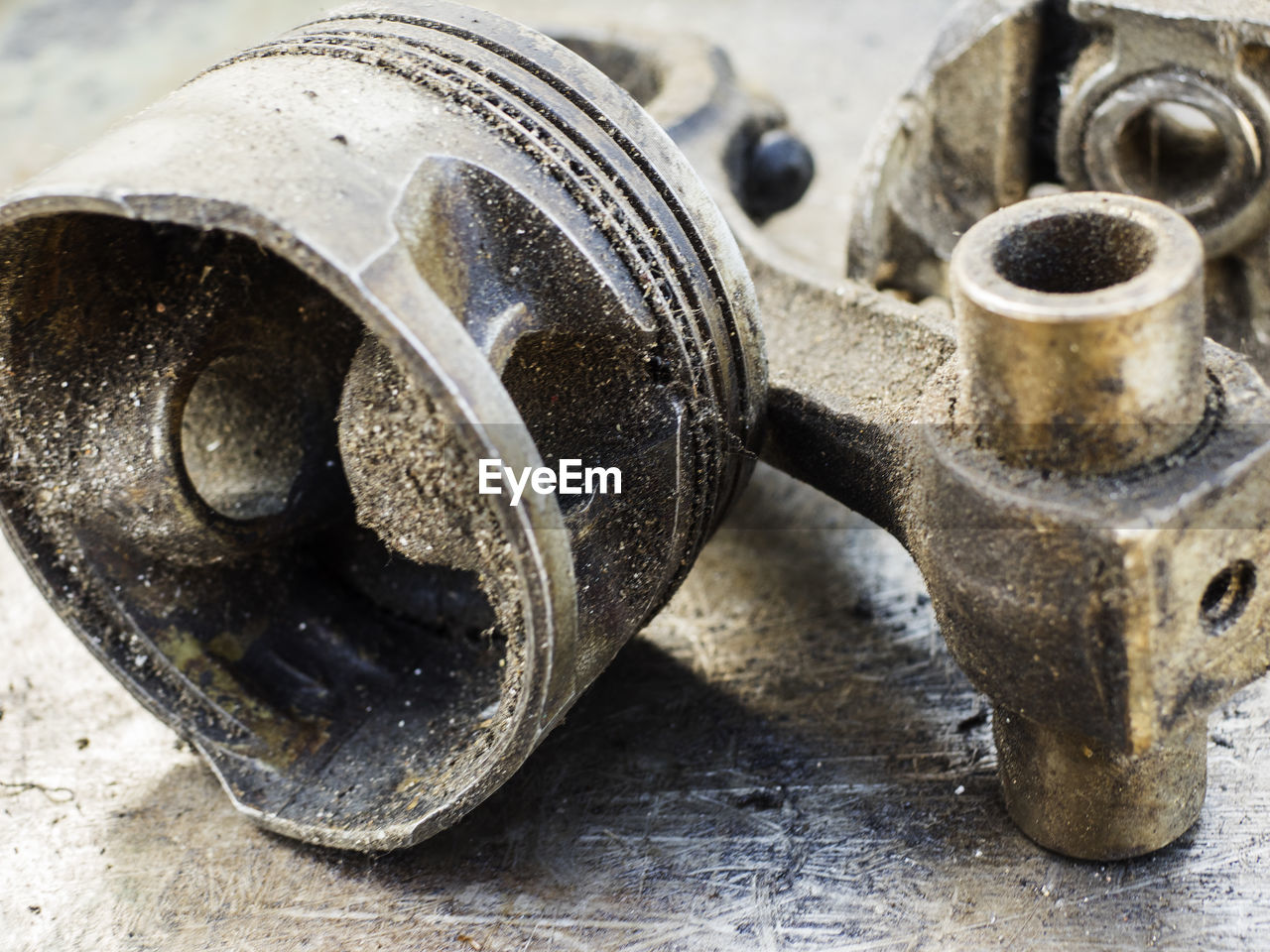 Close-up of broken piston on metal table