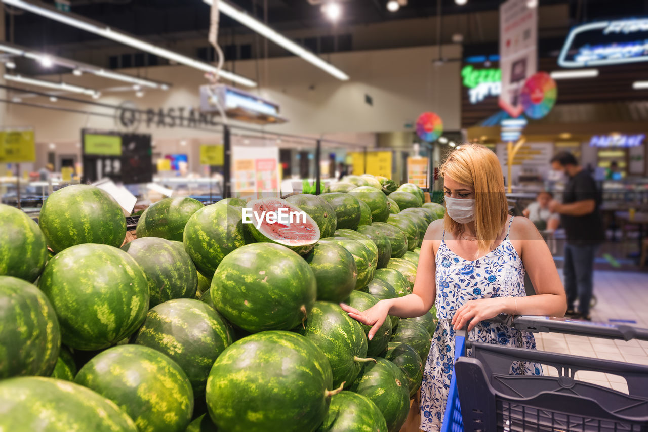 Woman wearing mask shopping at mall