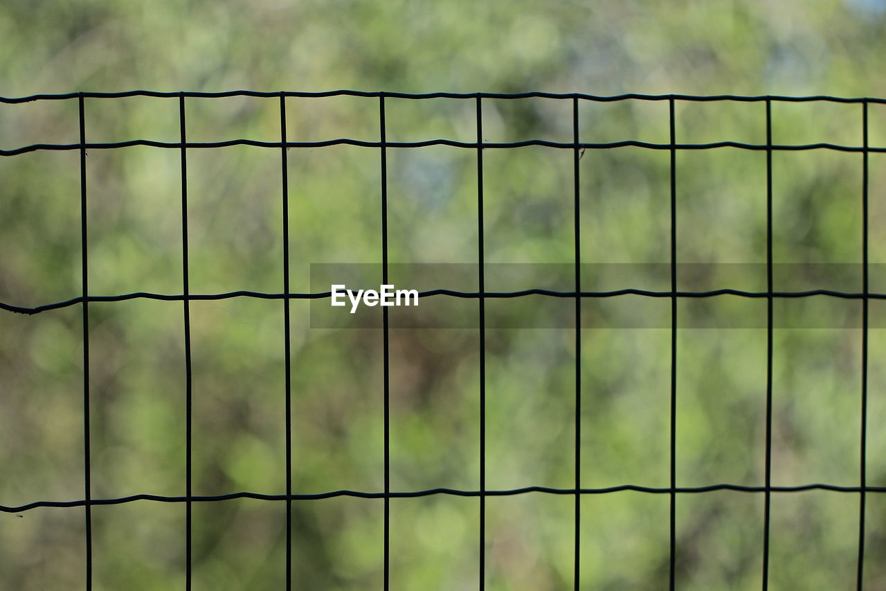 FULL FRAME SHOT OF FENCE AGAINST METAL GRATE