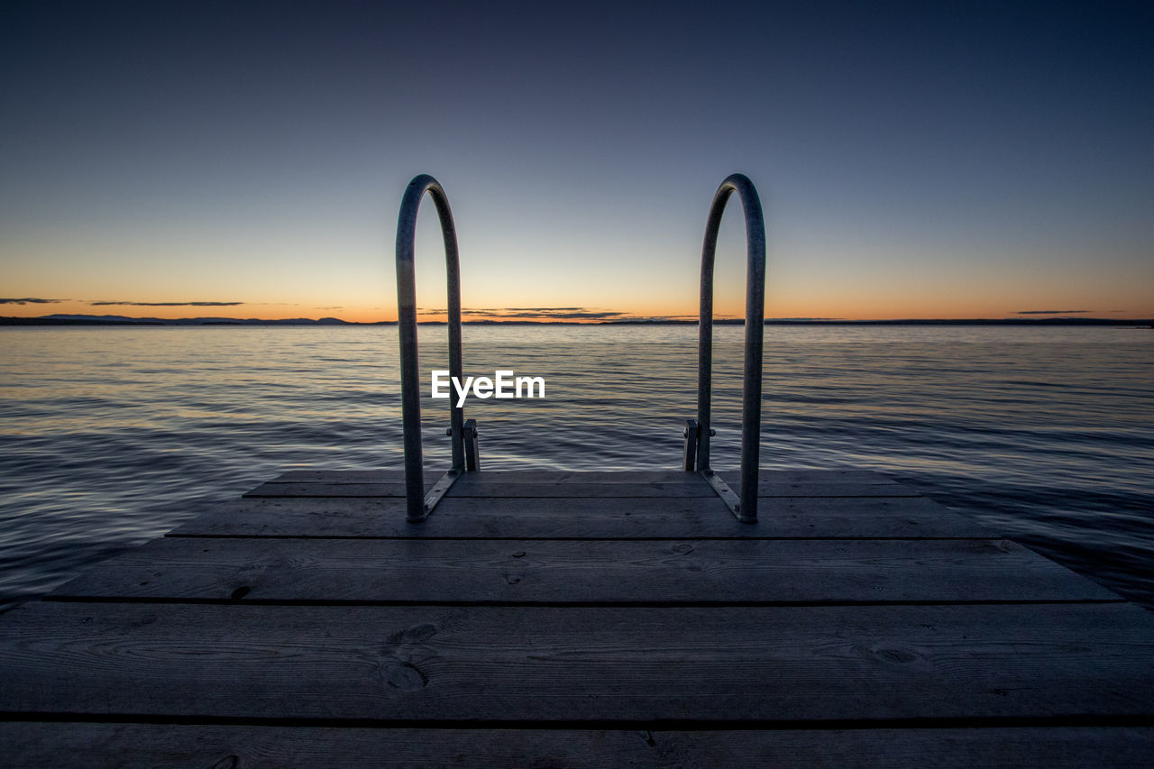 Scenic view of sea against sky at sunset