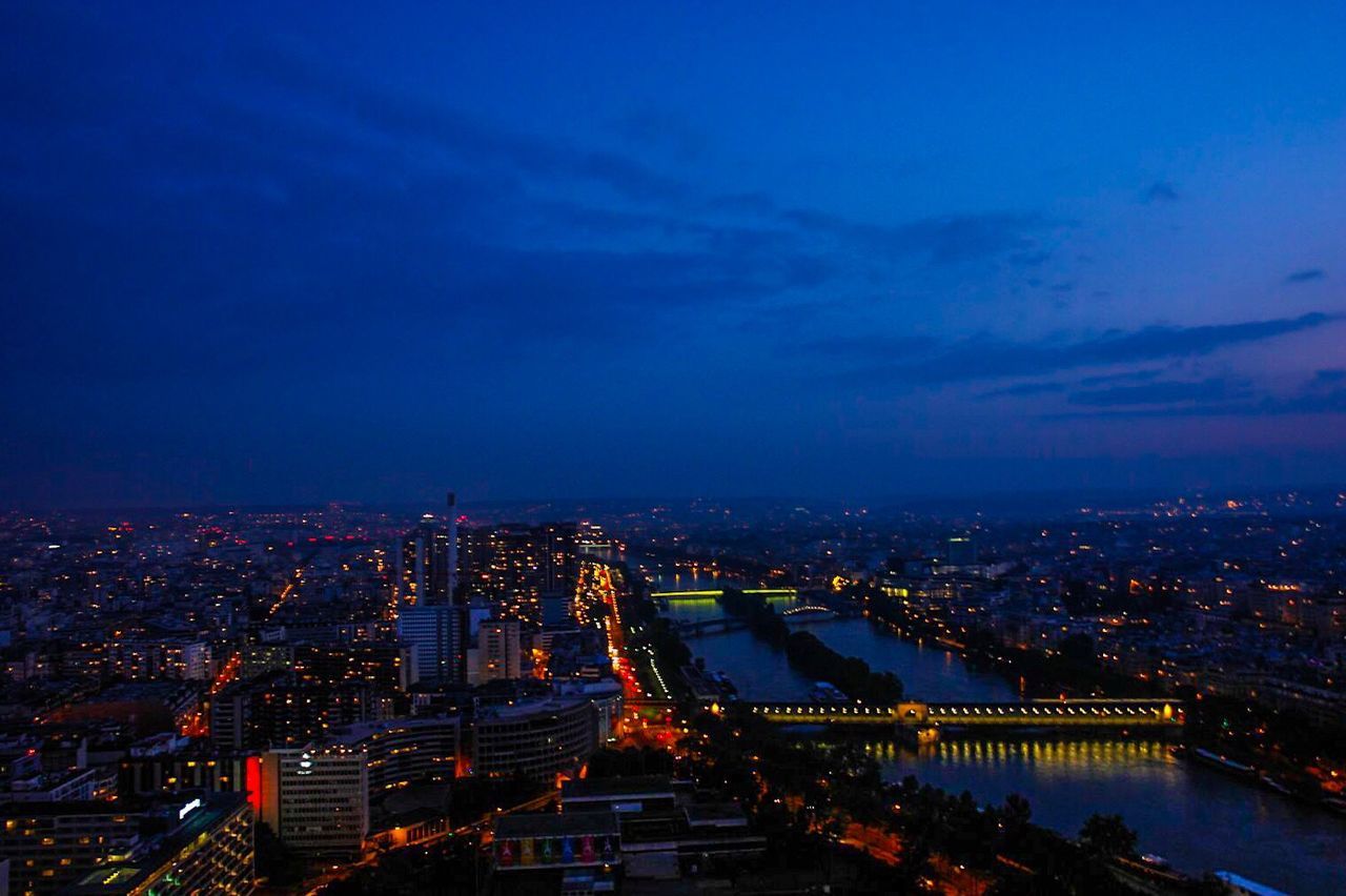 ILLUMINATED CITYSCAPE AGAINST SKY AT NIGHT