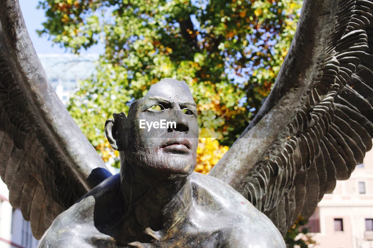 Low angle view of statue against trees