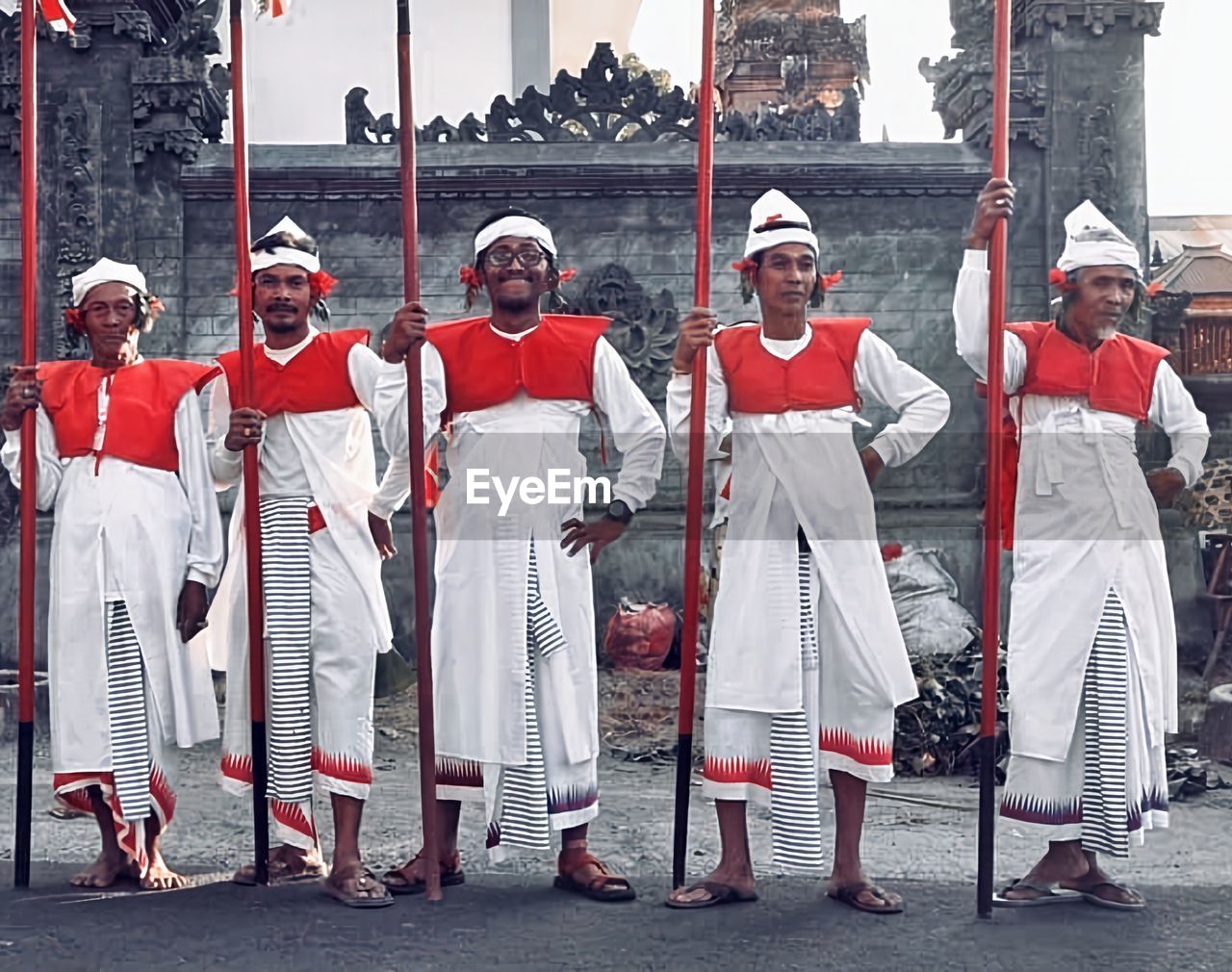 group of people, clothing, full length, person, architecture, tradition, men, traditional clothing, musician, adult, headwear, day, sports, outdoors, performance, uniform, standing, history, city