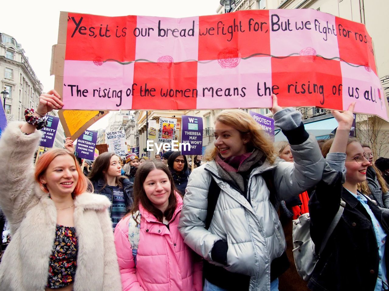 WOMEN STANDING AGAINST PEOPLE