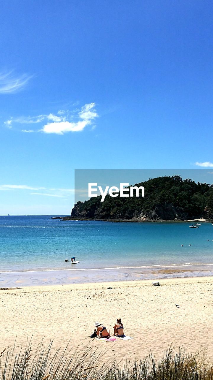 Scenic view of beach against clear blue sky