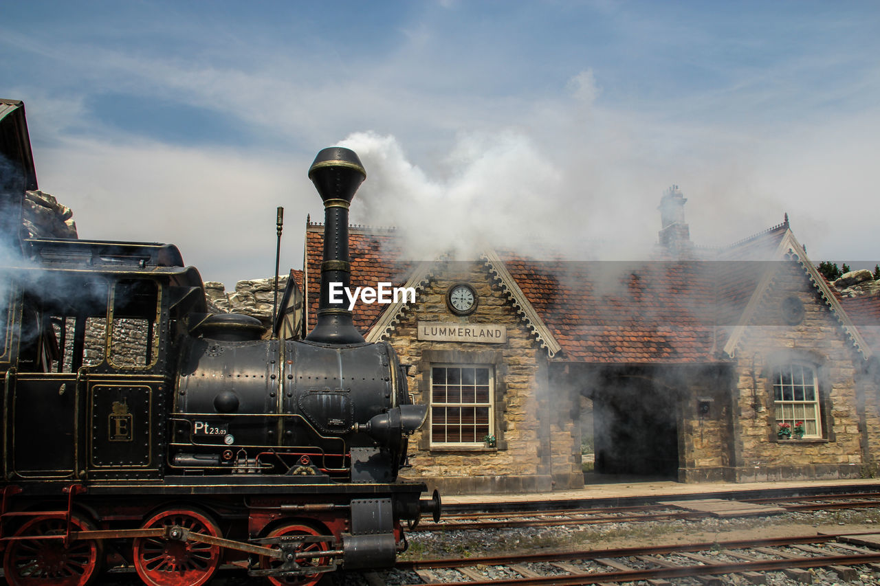 Train on railroad tracks against sky