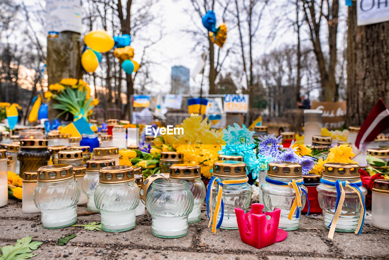 Thousands candles and flowers standing on the street during the war in ukraine