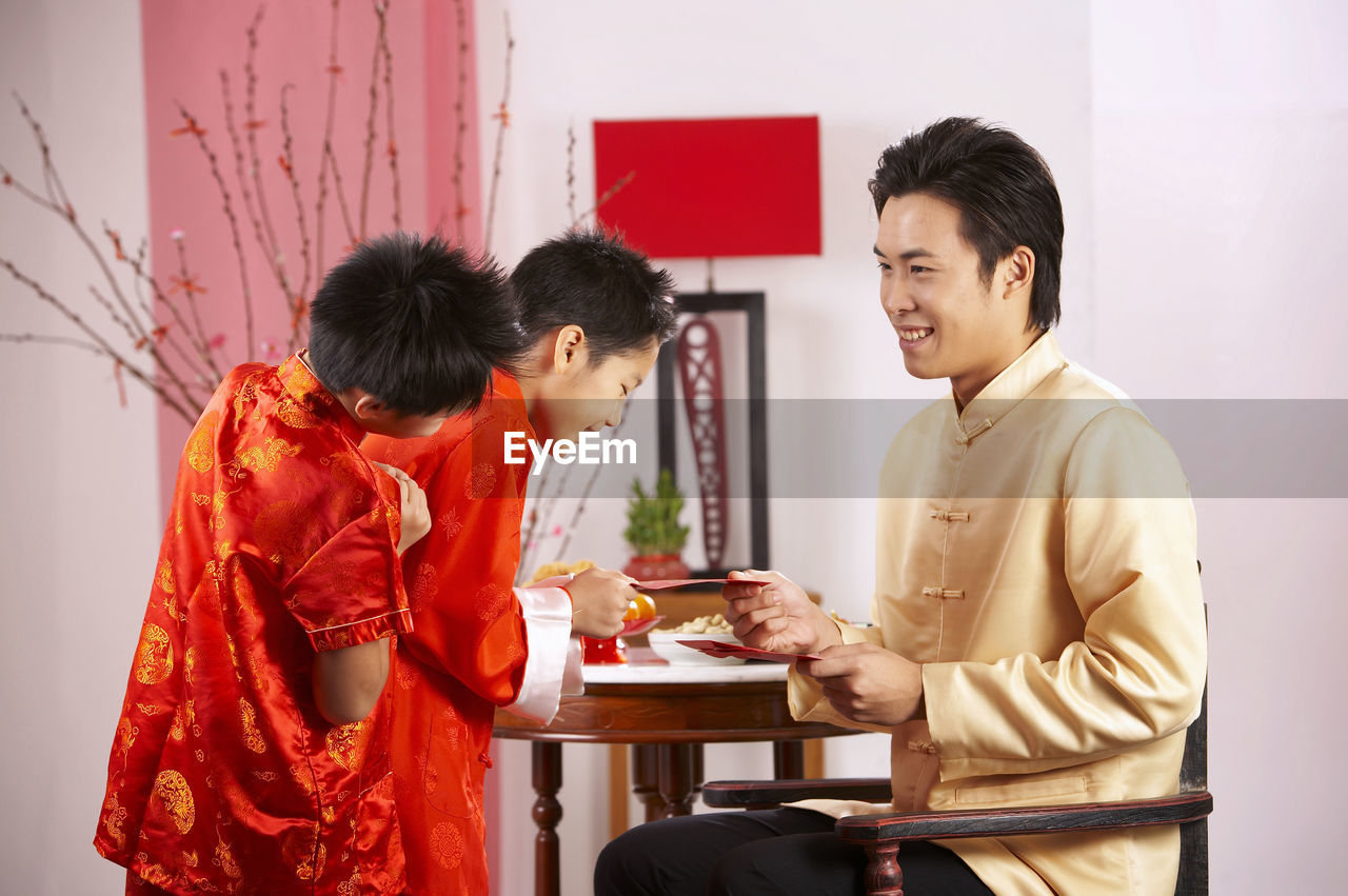 Father greeting sons during festival