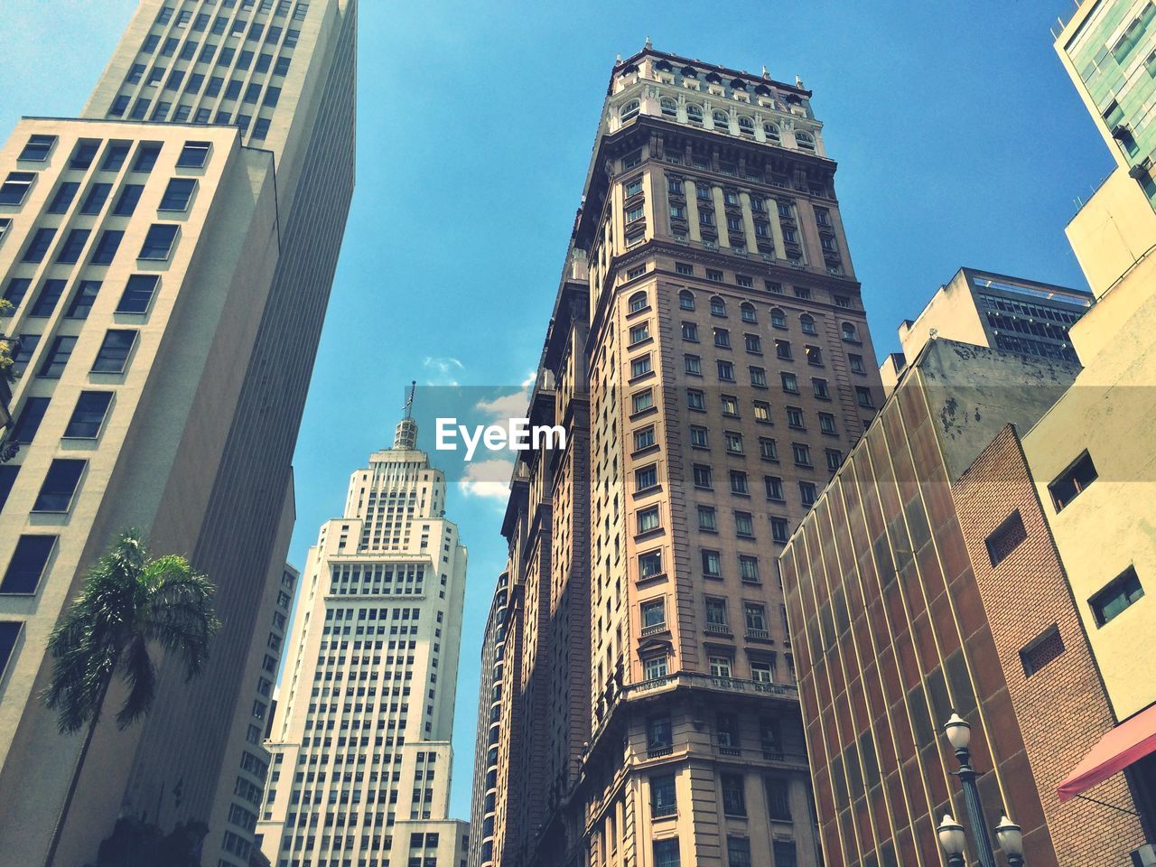 Low angle view of modern buildings in city against sky