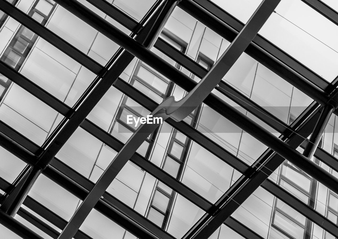 LOW ANGLE VIEW OF SKYLIGHT IN GLASS BUILDING