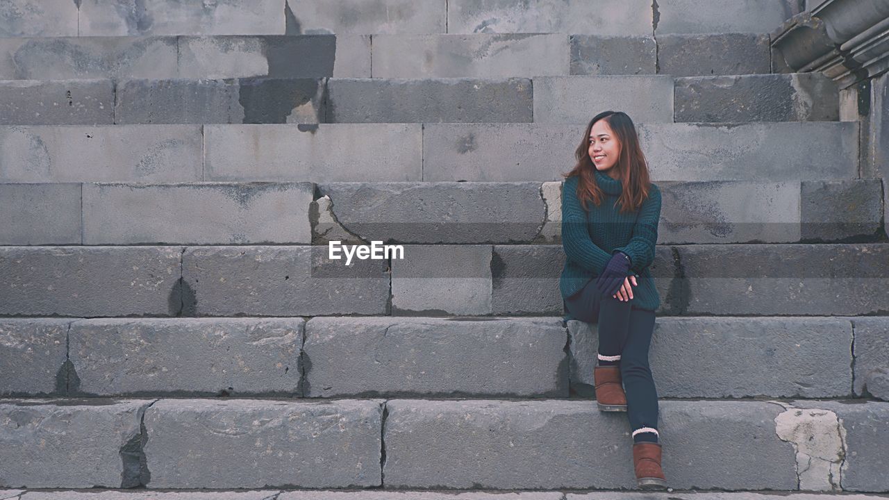 Young woman sitting steps