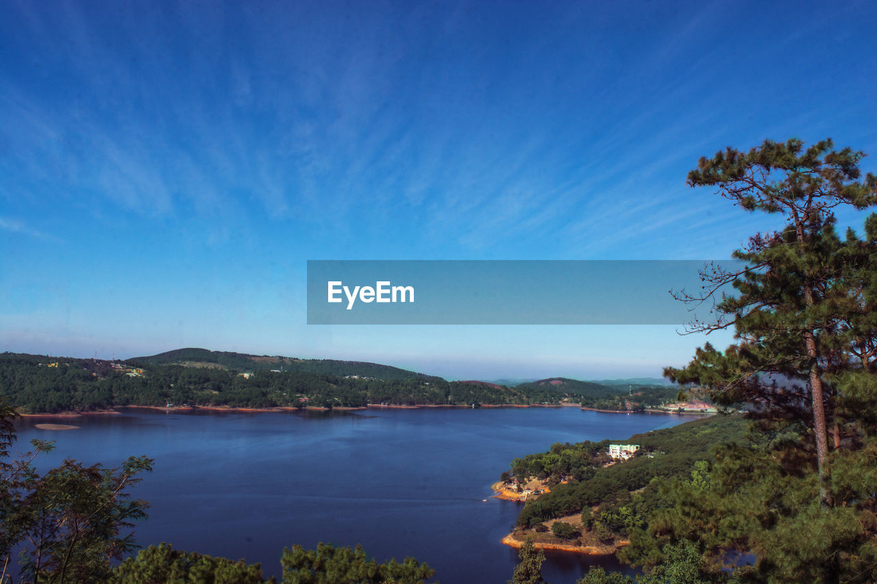 Scenic view of river against blue sky