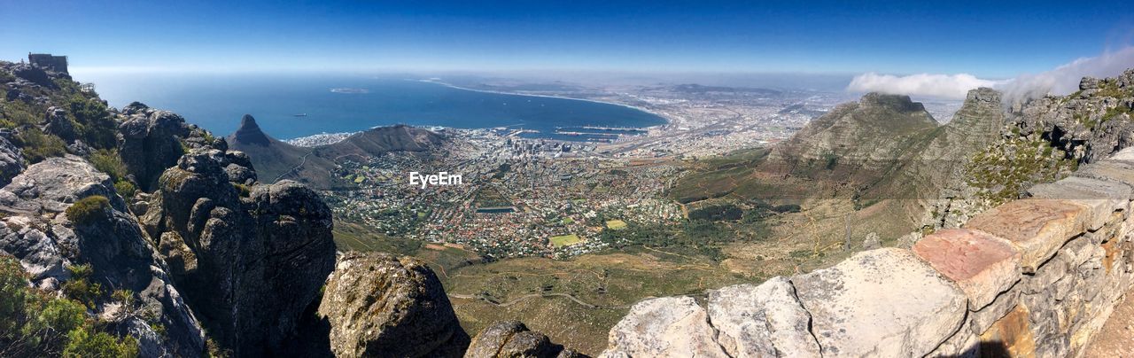High angle view of sea and mountains against sky