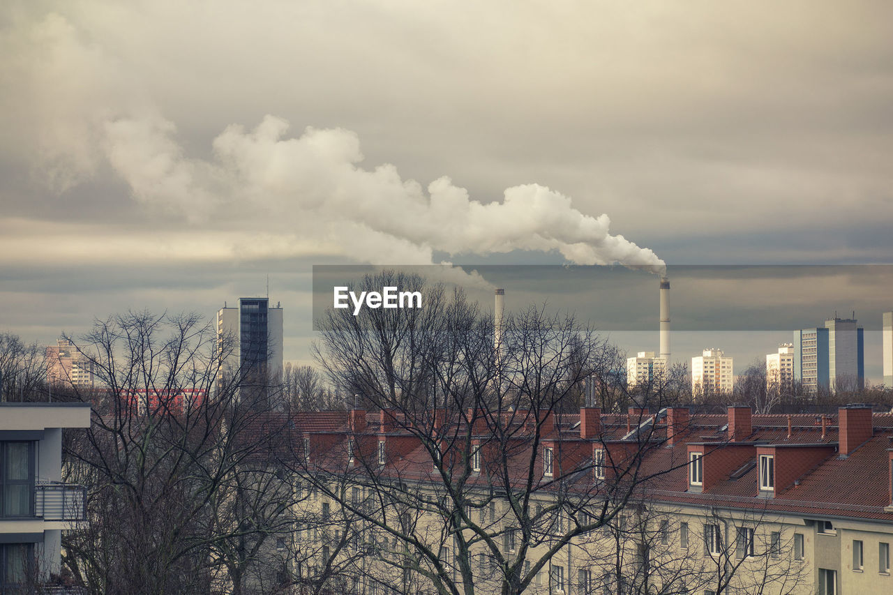 CITY BUILDINGS AGAINST CLOUDY SKY