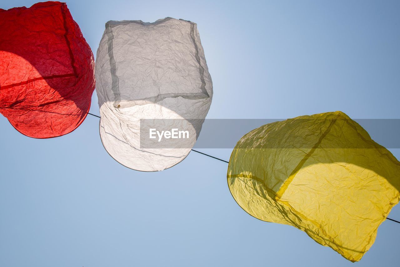 Low angle view of paper lantern hanging against clear sky