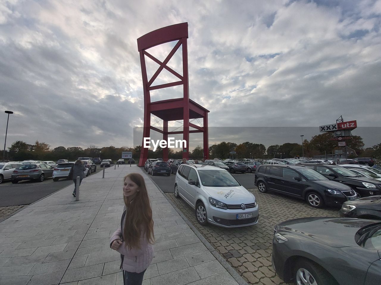 WOMAN STANDING ON ROAD AGAINST SKY