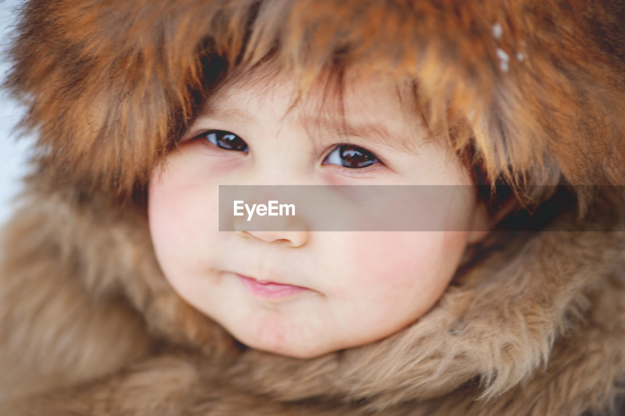 Close-up portrait of cute girl wearing warm clothing during winter