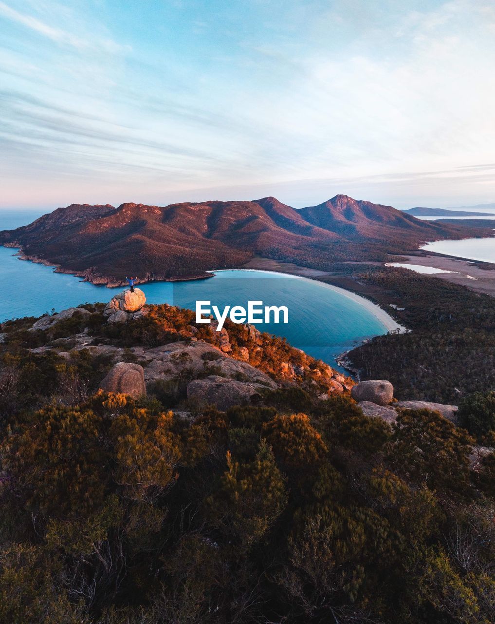 Scenic view of sea and mountains against sky