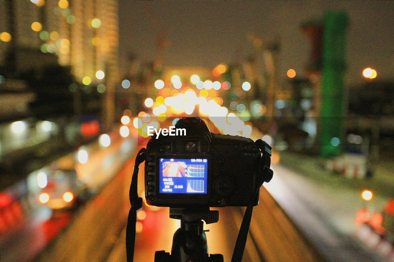 Illuminated city street seen through camera