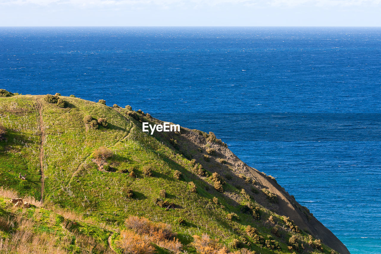 Seacoast on small island gozo, malta. natural sescape with beautiful green coast.