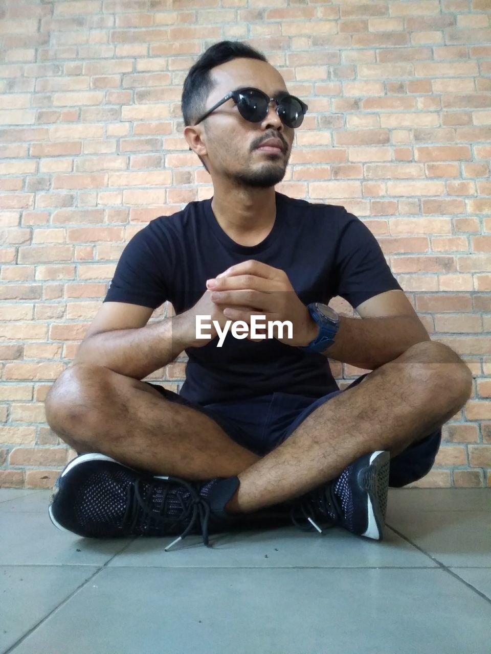 MAN SITTING ON WALL