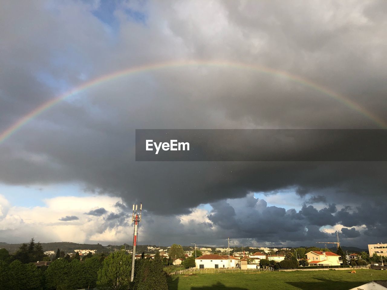 SCENIC VIEW OF RAINBOW OVER CITY BUILDINGS