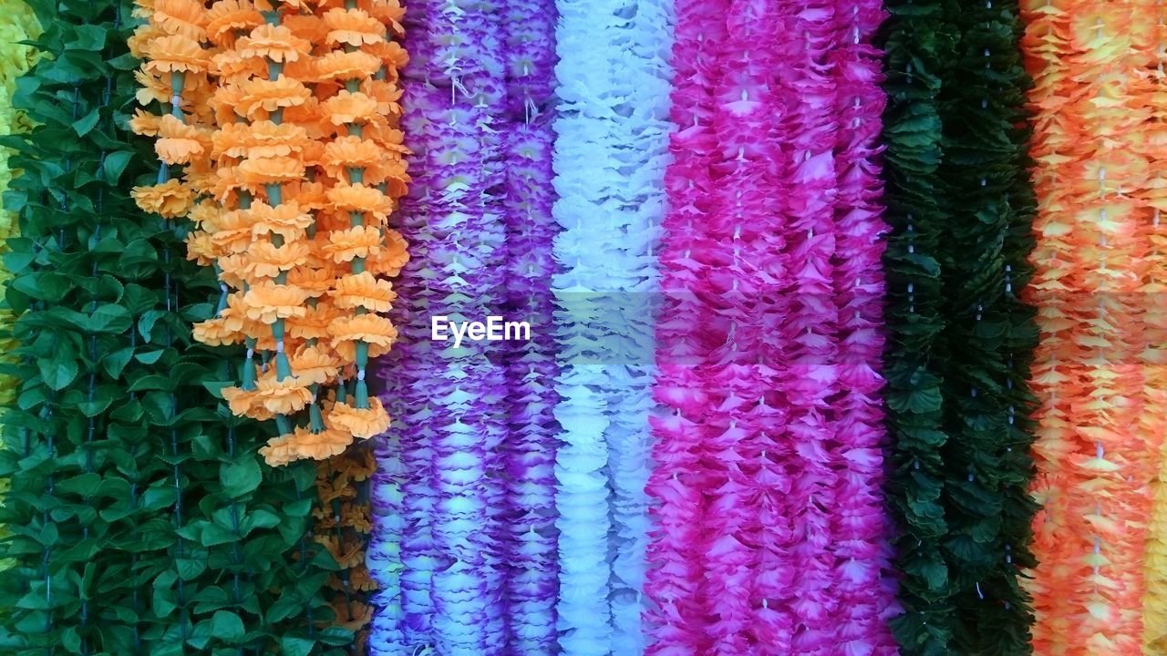 Full frame shot of artificial floral garlands