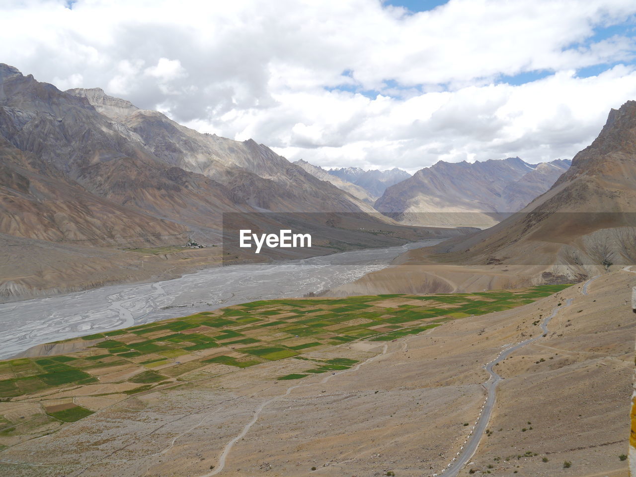 Tranquil view of mountain landscape against clouds