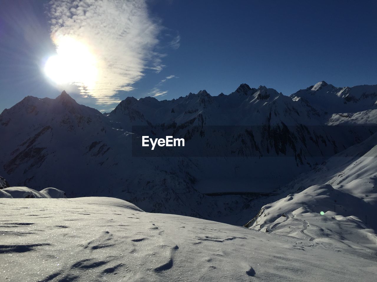 Scenic view of snowcapped mountains against sky