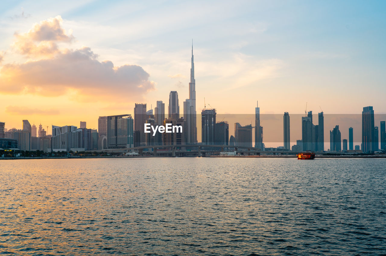 Dubai skyline during sunset dusk and night series from the water canal