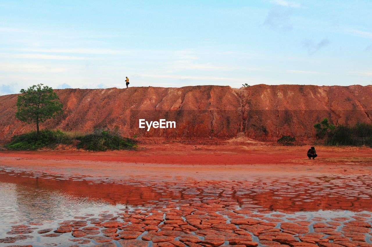 People on landscape against sky