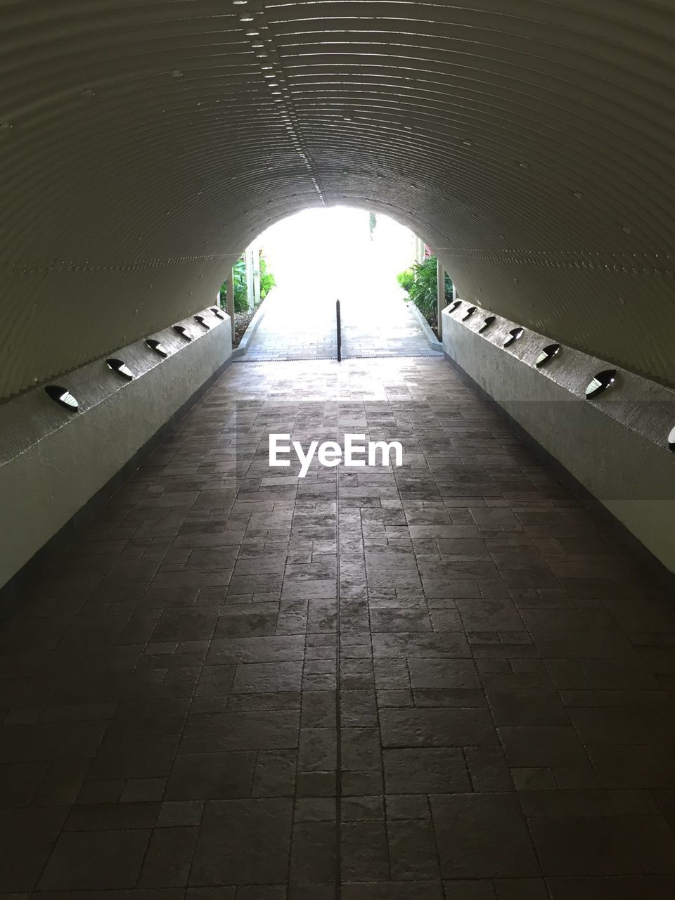 WALKWAY IN ILLUMINATED TUNNEL