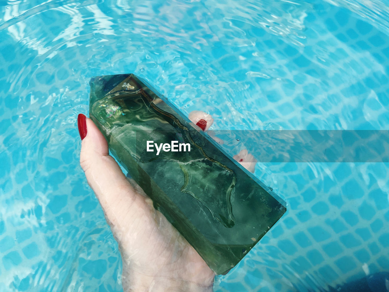 LOW SECTION OF PERSON WEARING FISH SWIMMING POOL