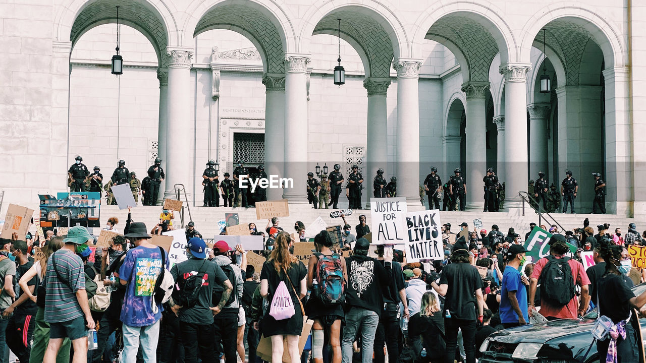 GROUP OF PEOPLE OUTSIDE BUILDING