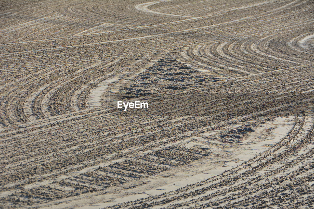 High angle view of tire tracks on road