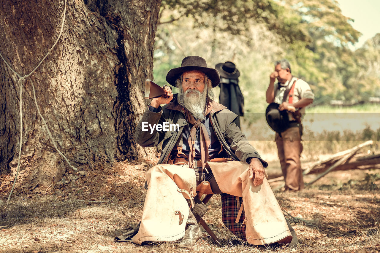 Portrait of senior man sitting in forest