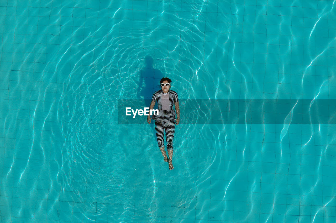 Directly above shot of woman swimming in pool