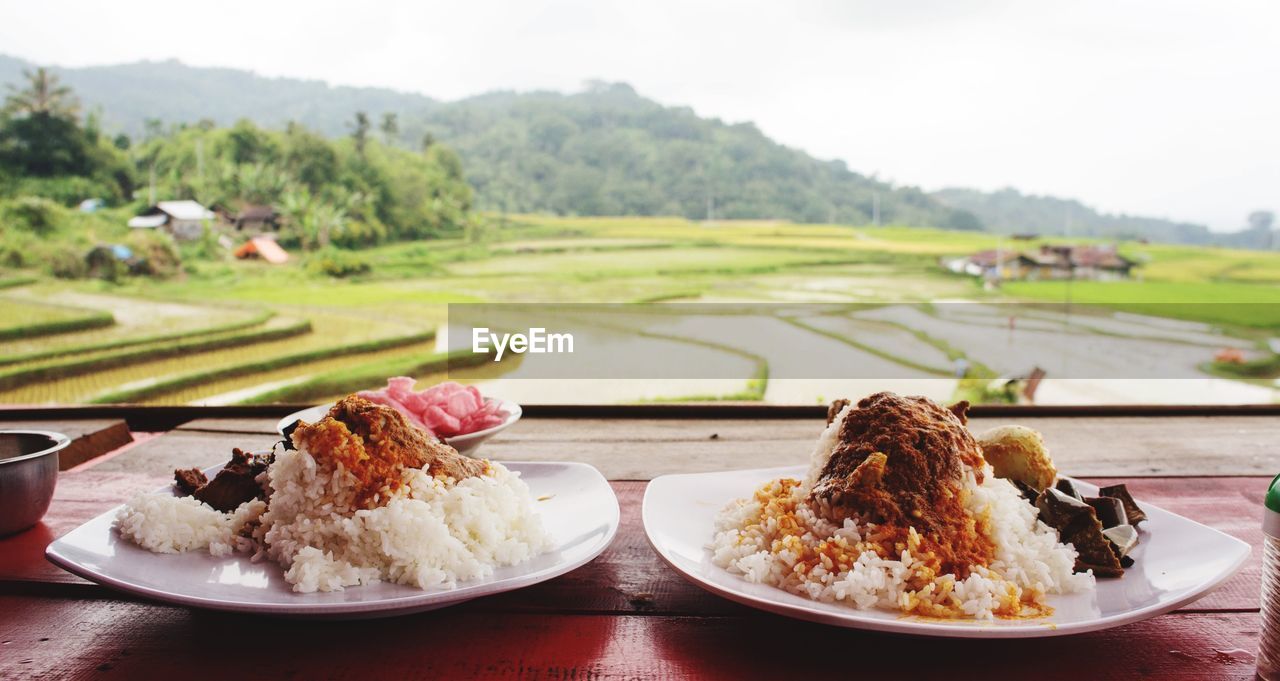 Close-up of food served on table by window