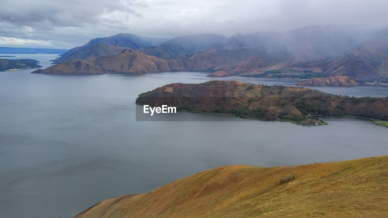 Scenic view of lake and mountains against sky